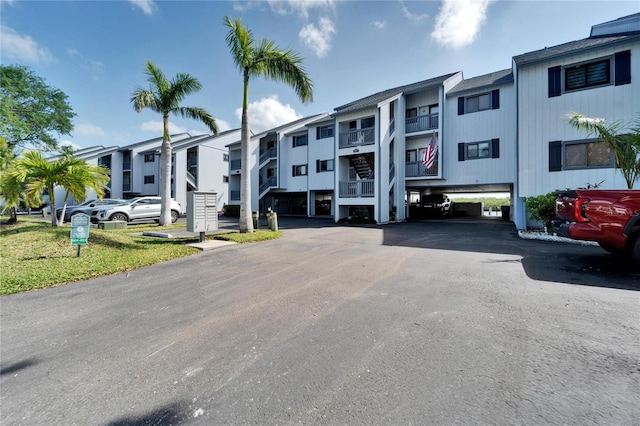 view of property featuring a parking lot and a residential view
