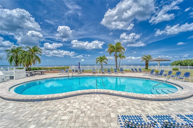 pool with fence and a patio