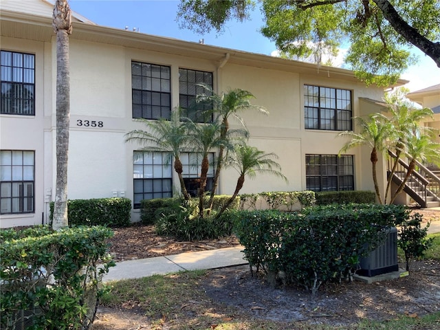 3358 Mermoor Dr Unit 2106, Palm Harbor, FL 34685 - exterior space with stucco siding, central AC, and stairway
