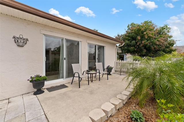 view of patio featuring fence