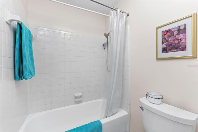 bathroom featuring toilet and shower / bath combination with curtain