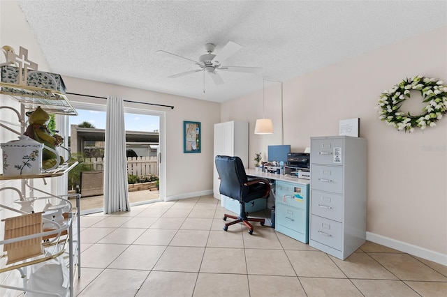 home office featuring light tile patterned flooring, a textured ceiling, baseboards, and a ceiling fan
