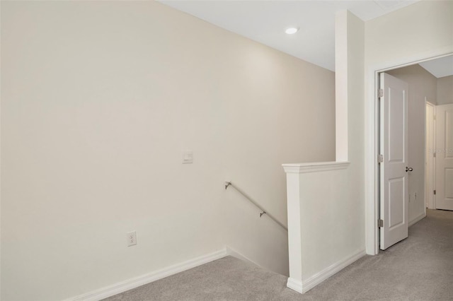 staircase featuring carpet floors and baseboards