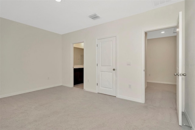 unfurnished bedroom featuring light carpet, baseboards, and visible vents