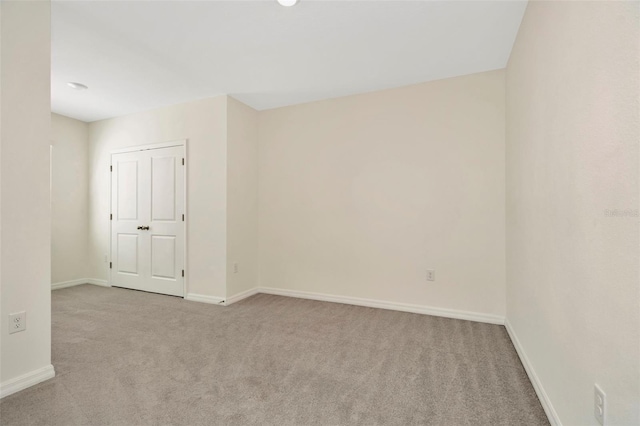 carpeted empty room with baseboards
