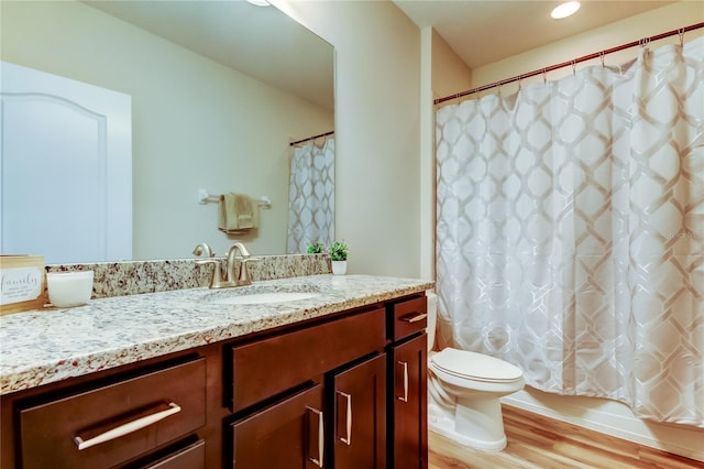 13217 Canopy Creek Dr, Tampa, FL 33625 - full bath with vanity, toilet, wood finished floors, and shower / tub combo with curtain