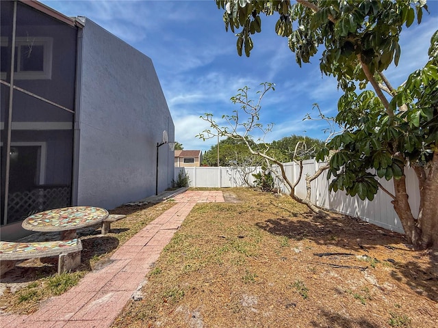 view of yard with a lanai and a fenced backyard