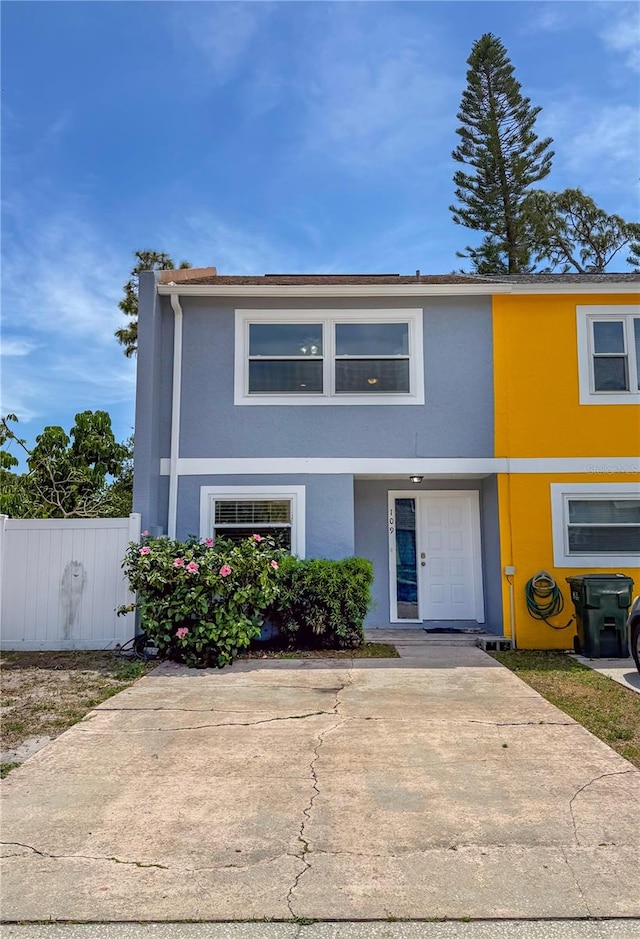 view of property with fence and stucco siding
