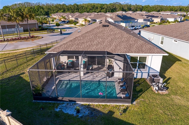 1044 Manzanar Pl, Wesley Chapel, FL 33543 - back of property featuring roof with shingles, a patio area, a residential view, and glass enclosure