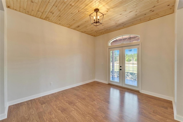 14807 Capps Estates Ln, Wimauma, FL 33598 - unfurnished room with french doors, wooden ceiling, a chandelier, and wood finished floors