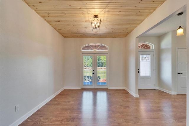 14807 Capps Estates Ln, Wimauma, FL 33598 - entrance foyer featuring wood ceiling, plenty of natural light, wood finished floors, and french doors