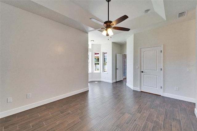 14807 Capps Estates Ln, Wimauma, FL 33598 - unfurnished room with a ceiling fan, dark wood finished floors, and a raised ceiling