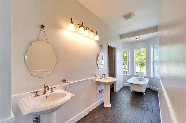 14807 Capps Estates Ln, Wimauma, FL 33598 - bathroom with a freestanding bath and wood finished floors