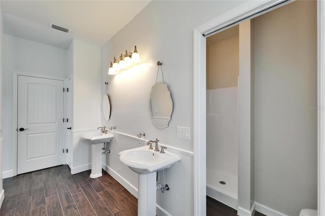 14807 Capps Estates Ln, Wimauma, FL 33598 - bathroom featuring wood finished floors and a shower
