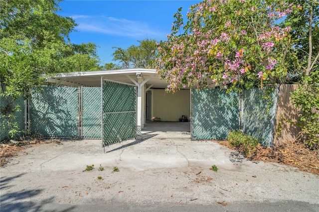view of property exterior with an attached carport and fence