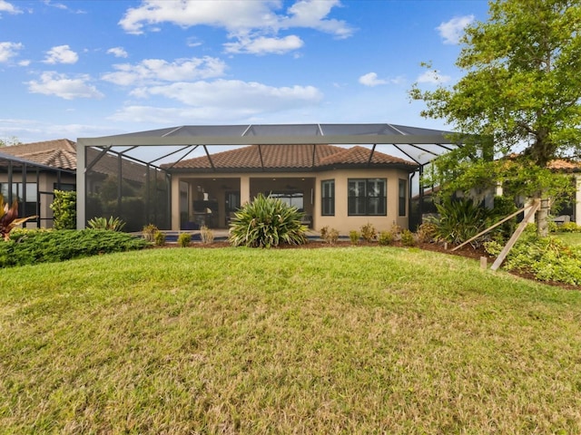 11248 Juglans Dr, Odessa, FL 33556 - rear view of property featuring a lanai, a tiled roof, stucco siding, and a yard