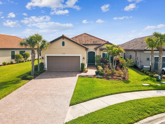 11248 Juglans Dr, Odessa, FL 33556 - mediterranean / spanish-style house with stucco siding, decorative driveway, a garage, and a front lawn