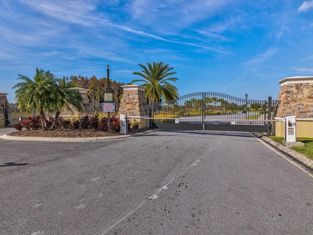 11248 Juglans Dr, Odessa, FL 33556 - view of road featuring a gate, a gated entry, and curbs
