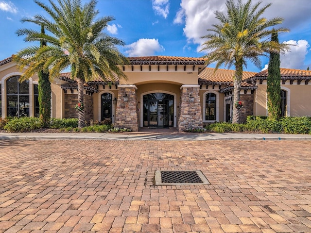 11248 Juglans Dr, Odessa, FL 33556 - mediterranean / spanish house with stucco siding, a tiled roof, and stone siding