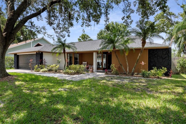 4715 Kemble Ct, Tampa, FL 33624 - single story home with a shingled roof, driveway, a front yard, and a garage