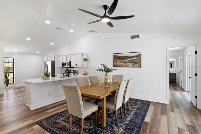 4715 Kemble Ct, Tampa, FL 33624 - dining space featuring ceiling fan, visible vents, vaulted ceiling, and wood finished floors