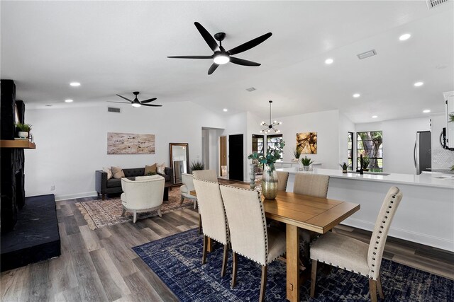 4715 Kemble Ct, Tampa, FL 33624 - dining room featuring visible vents, ceiling fan with notable chandelier, lofted ceiling, and wood finished floors