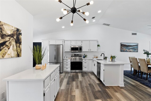 4715 Kemble Ct, Tampa, FL 33624 - kitchen with light countertops, visible vents, a peninsula, stainless steel appliances, and a sink