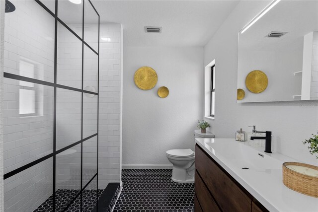 4715 Kemble Ct, Tampa, FL 33624 - full bath featuring visible vents, baseboards, a tile shower, toilet, and vanity