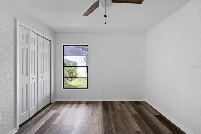 4715 Kemble Ct, Tampa, FL 33624 - unfurnished bedroom with a ceiling fan, baseboards, a closet, and dark wood finished floors