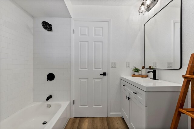 4715 Kemble Ct, Tampa, FL 33624 - full bath featuring bathing tub / shower combination, wood finished floors, and vanity