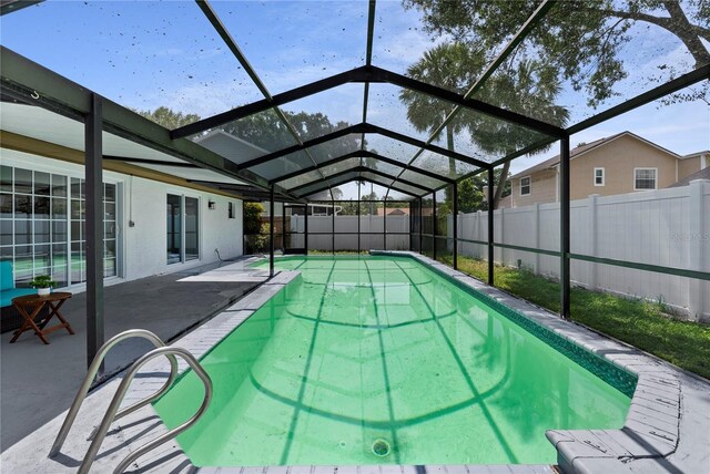 4715 Kemble Ct, Tampa, FL 33624 - view of swimming pool with a fenced backyard, glass enclosure, and a patio area