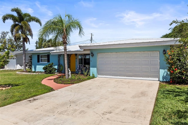 13979 Barbados Dr, Seminole, FL 33776 - single story home with stucco siding, metal roof, driveway, a front lawn, and an attached garage