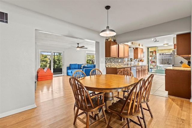 13979 Barbados Dr, Seminole, FL 33776 - dining area with baseboards, visible vents, ceiling fan, and light wood-style floors
