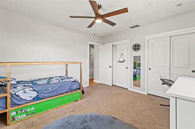 13979 Barbados Dr, Seminole, FL 33776 - bedroom with ceiling fan, two closets, visible vents, baseboards, and carpet floors