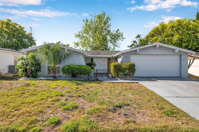 ranch-style home with driveway, cooling unit, a front lawn, an attached garage, and stucco siding