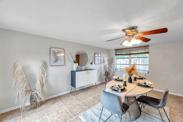 dining area with baseboards, a ceiling fan, a textured ceiling, and light tile patterned flooring