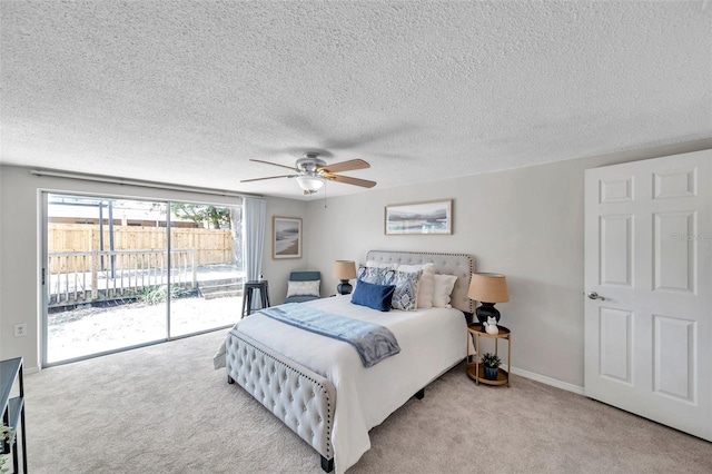 bedroom featuring access to outside, carpet, a ceiling fan, and a textured ceiling