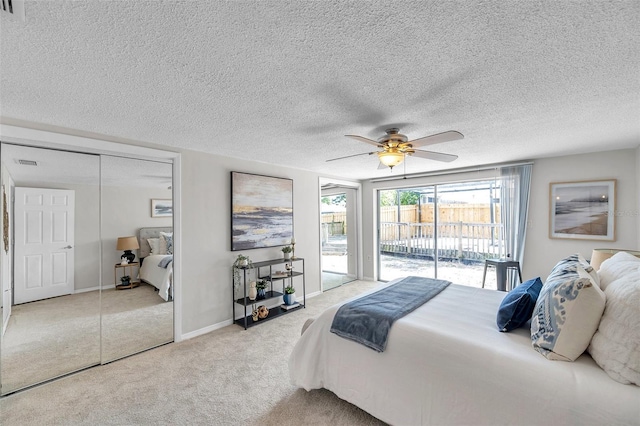 carpeted bedroom with ceiling fan, a textured ceiling, visible vents, access to exterior, and a closet
