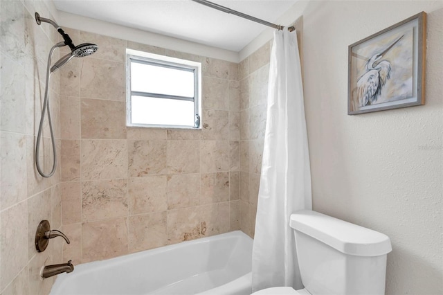 bathroom with shower / bath combo and toilet