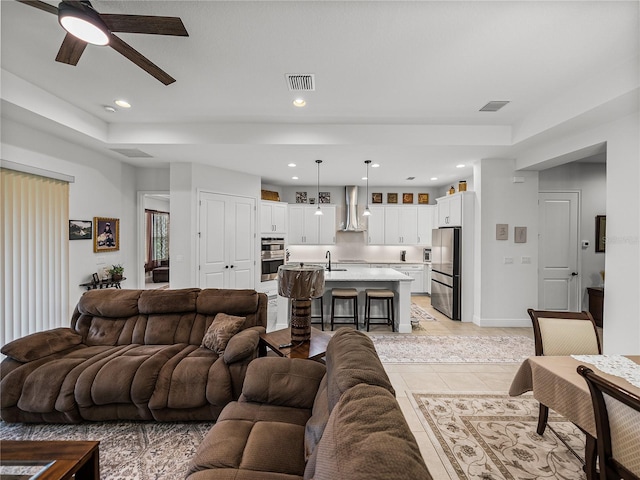living room with light tile patterned flooring, visible vents, recessed lighting, and a ceiling fan
