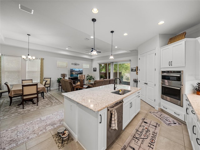 kitchen featuring a sink, stainless steel appliances, recessed lighting, and a raised ceiling