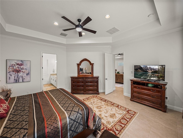 bedroom with a tray ceiling and visible vents
