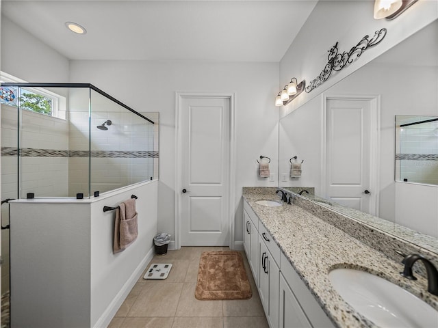 full bath featuring double vanity, a sink, and a stall shower