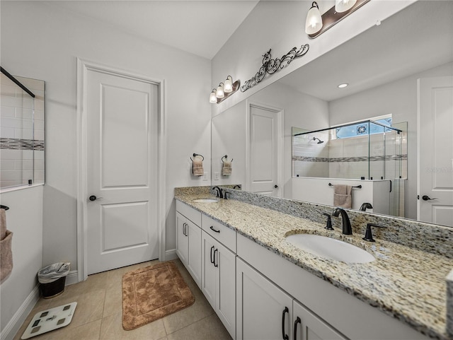 full bath with tile patterned floors, a sink, a stall shower, and double vanity