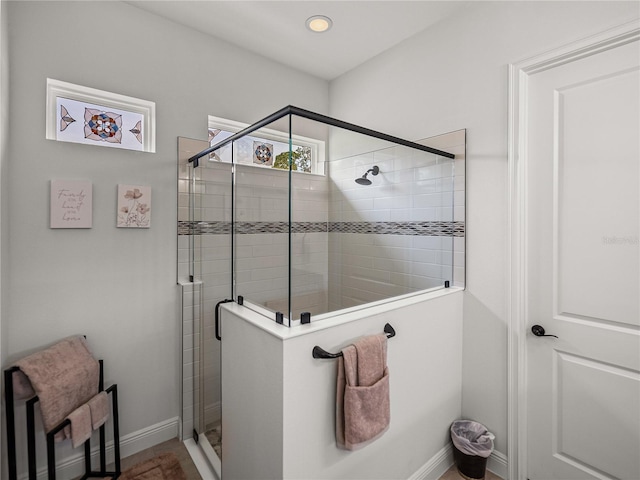 full bathroom with baseboards and a shower stall