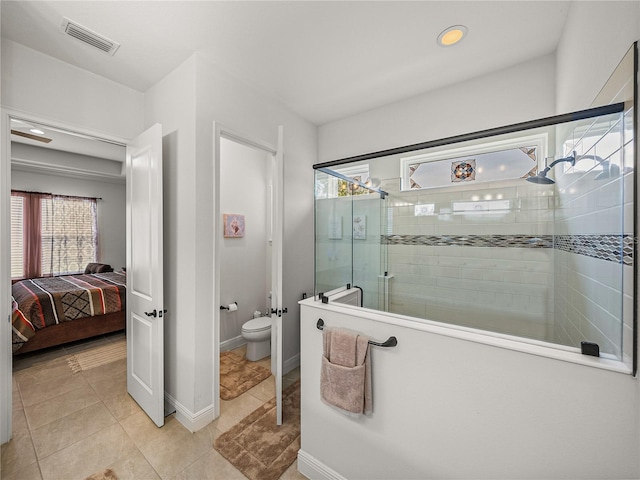 ensuite bathroom with toilet, baseboards, a stall shower, ensuite bath, and visible vents