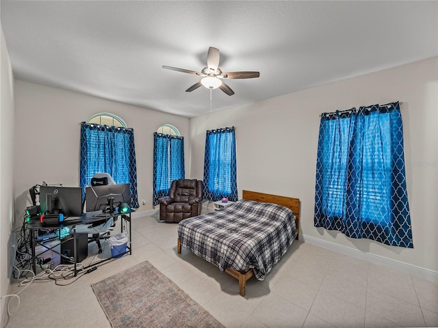 tiled bedroom with baseboards and ceiling fan