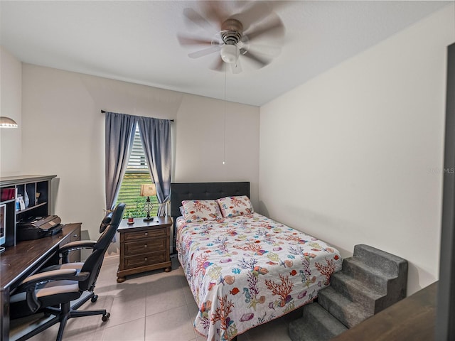 bedroom with ceiling fan and tile patterned flooring