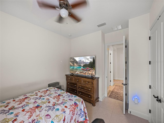 bedroom with baseboards, visible vents, and ceiling fan