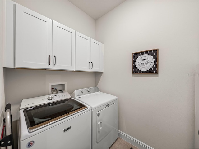 laundry area featuring cabinet space, washing machine and dryer, and baseboards